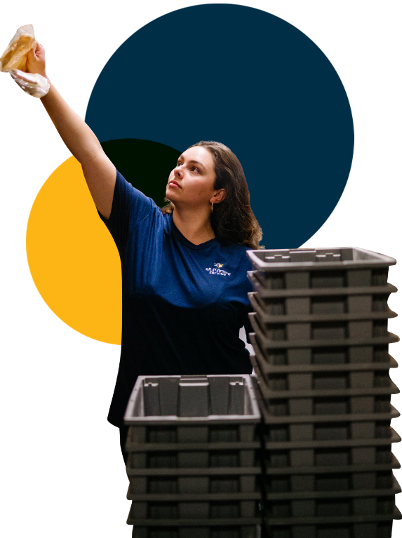 Lite PrepCenter Employee With Stacked Bins Reaching Left