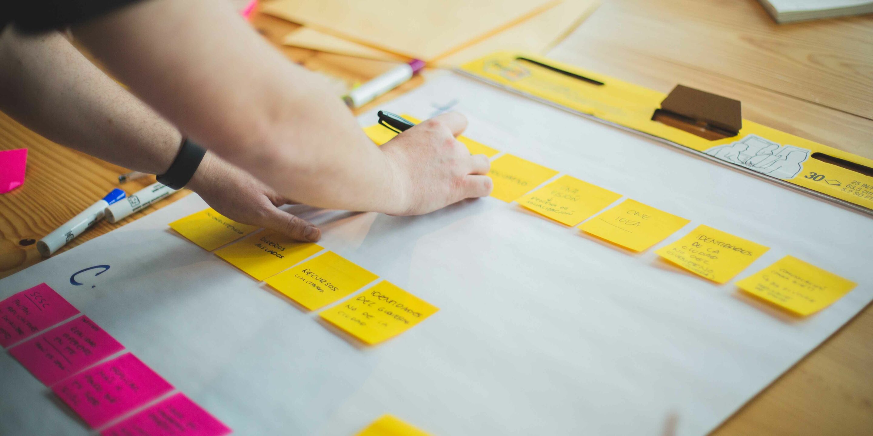 person in yellow sweater typing on computer