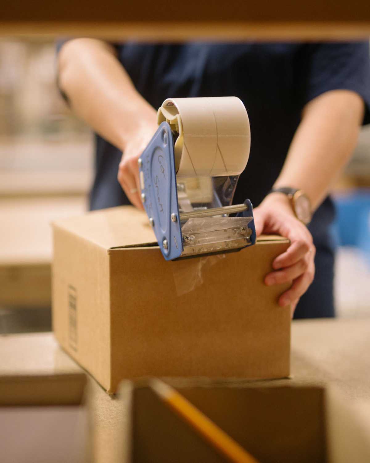 FBA prep image of warehouse employee prepping a amazon package for FBA Prep